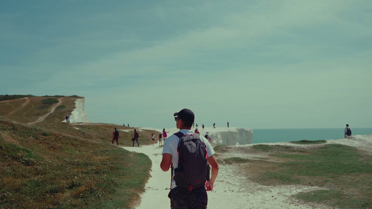 Hiker Walking Towards Seven Sisters Cliffs