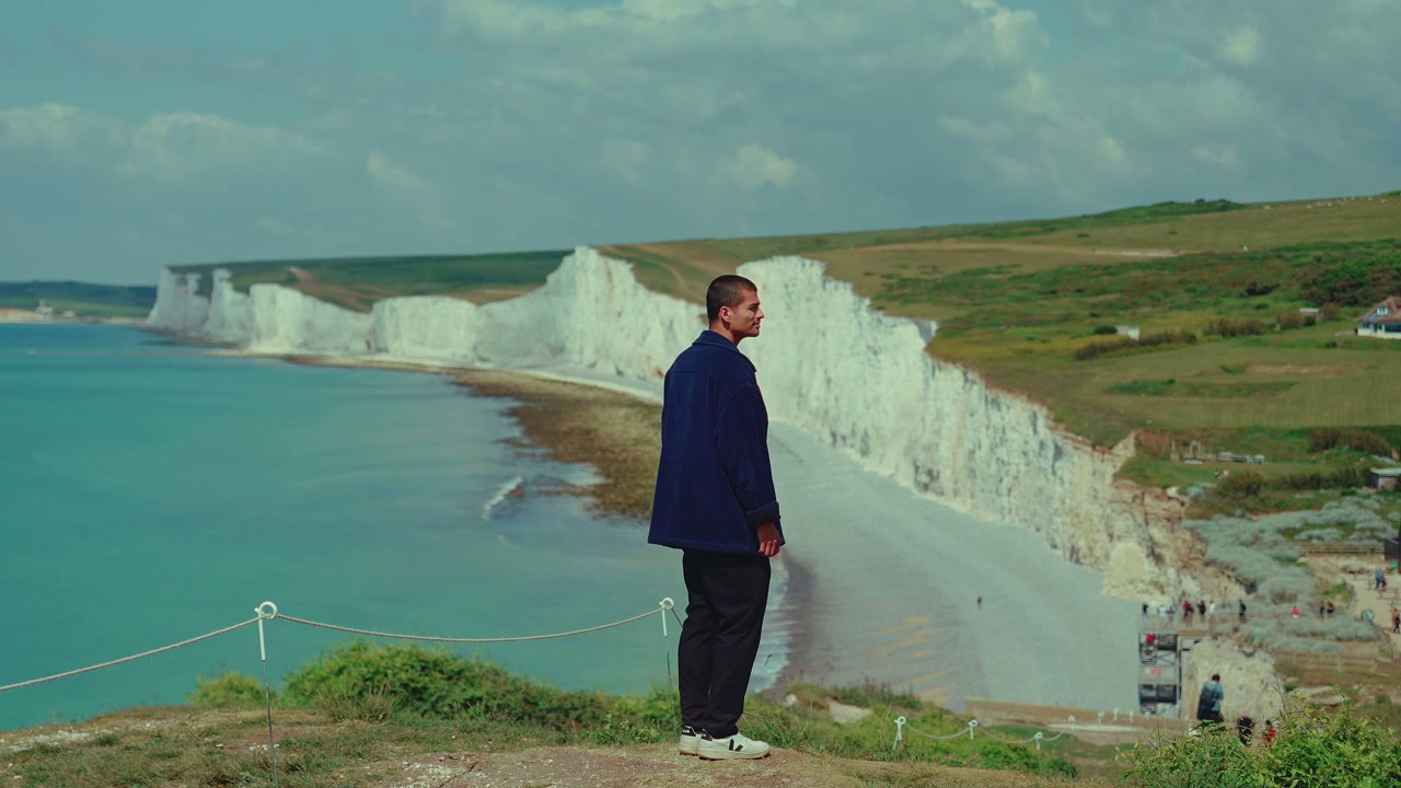 Man Standing Overlooking Seven Sisters Cliffs