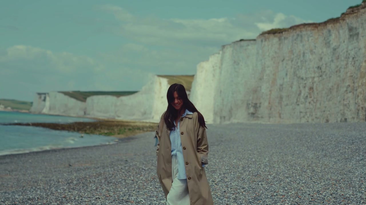 Woman Walking on Beach at Seven Sisters Cliffs
