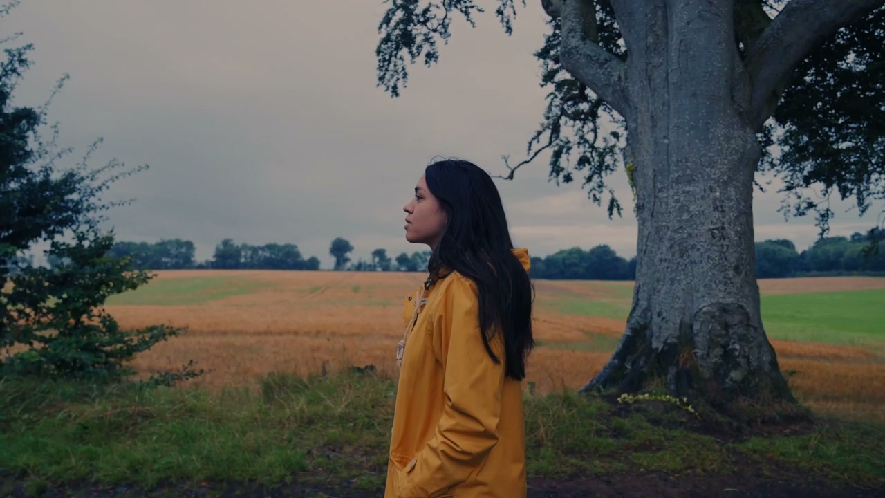 Woman Walking in Countryside Field