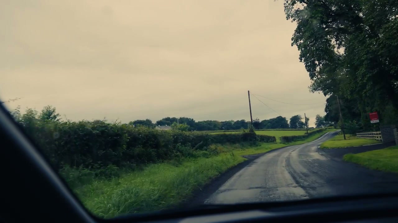Car Driving on Wet Country Road