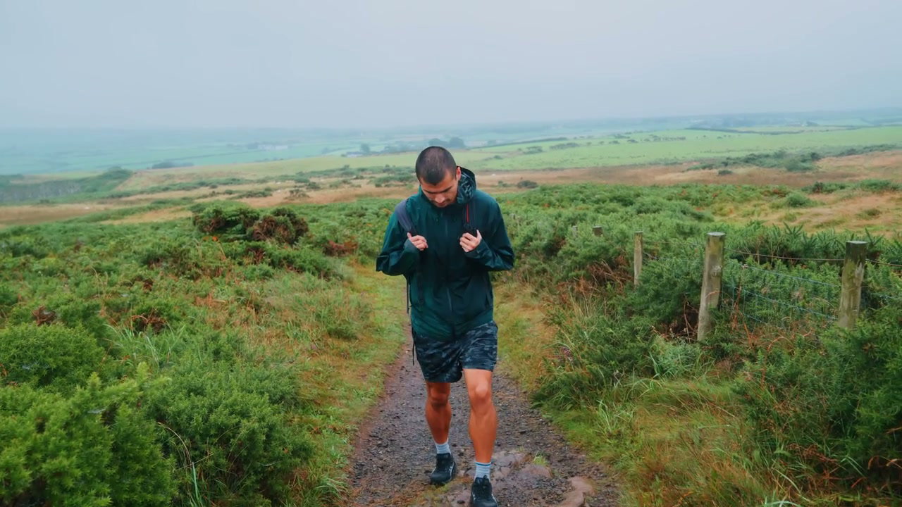 Man Hiking Coastal Trail at Giants Causeway
