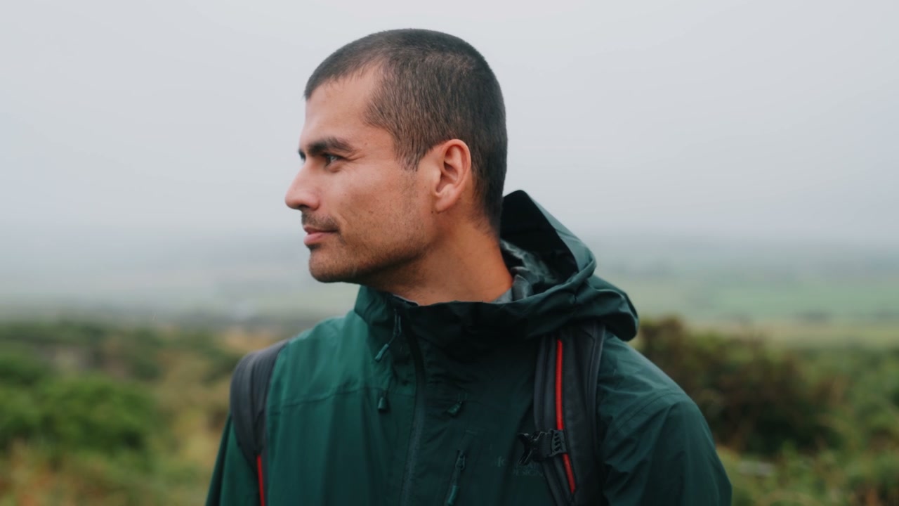 Hiker Looking Across Misty Landscape