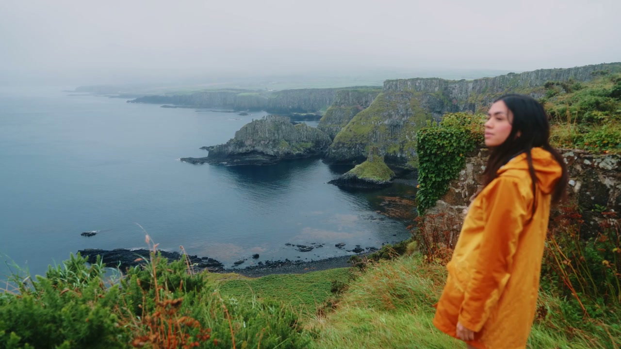 Woman Looking at Giant's Causeway Coastline