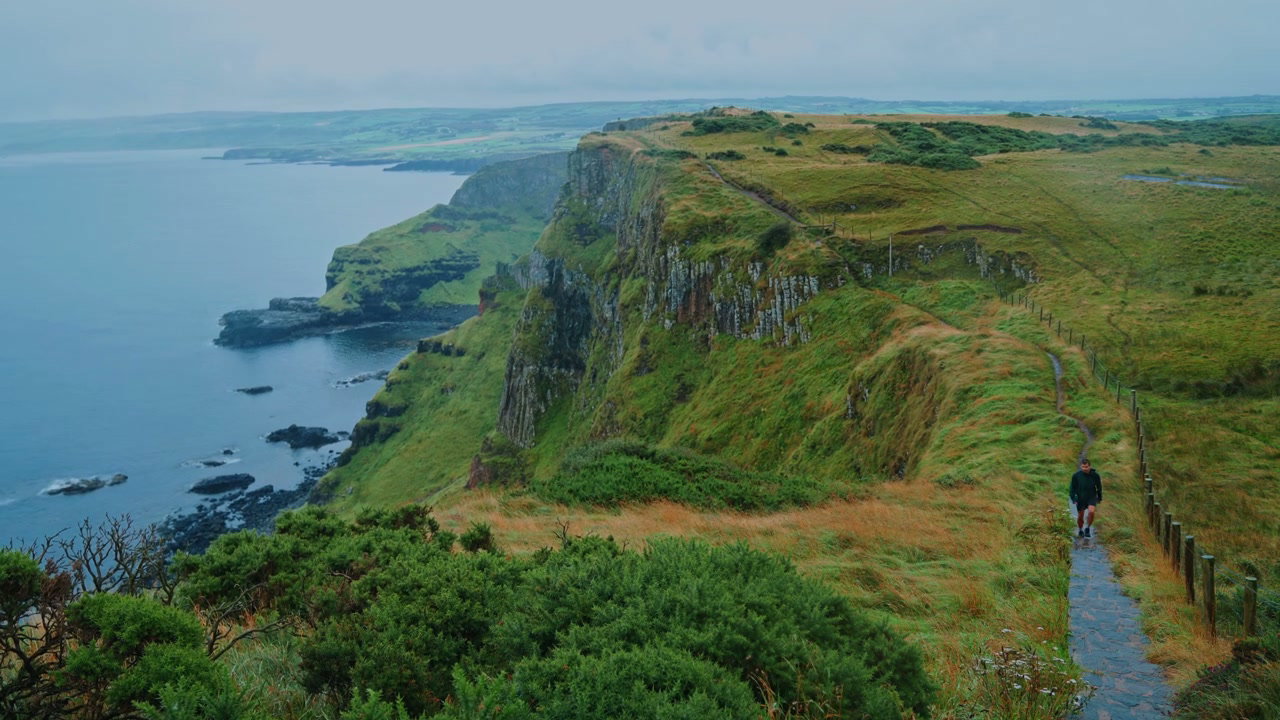 Hiker on Giant's Causeway Coastal Cliffs