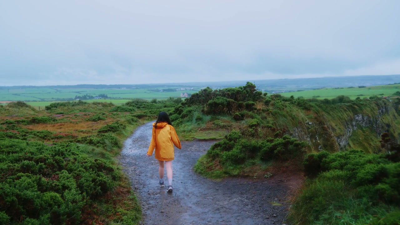 Woman Walking on Path at Giants Causeway