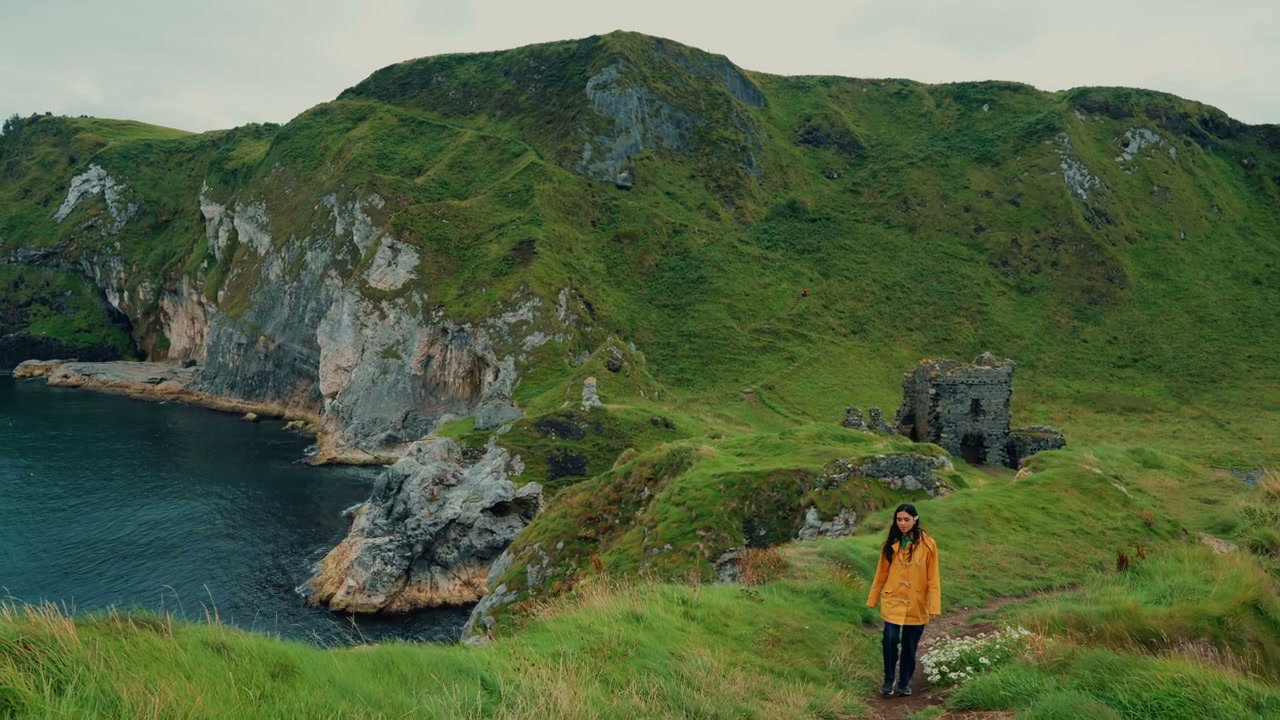 Woman Hiking on Coastal Path by Kinbane Castle