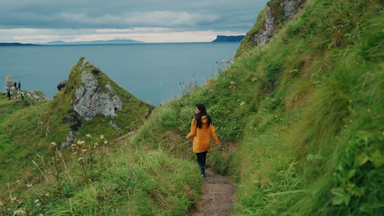 Woman Walking Coastal Path at Kinbane Castle