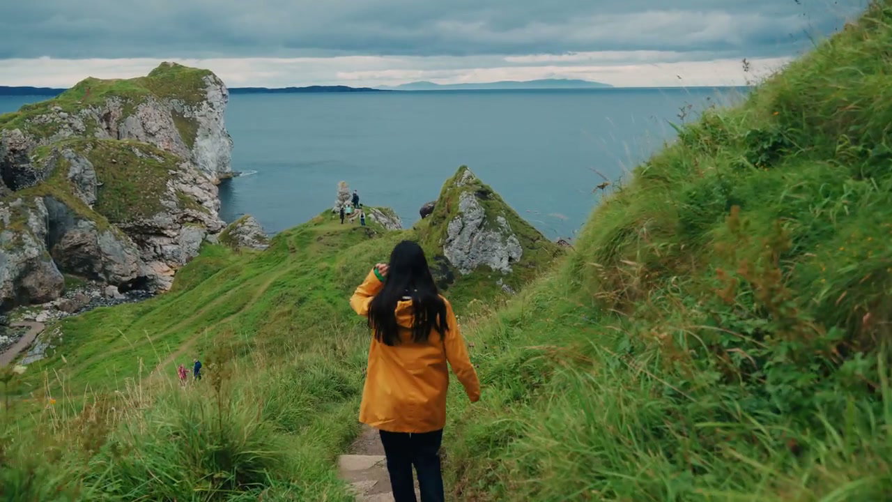 Woman Hiking Coastal Path at Kinbane Castle