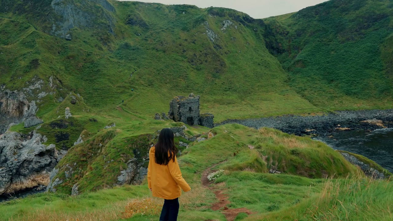 Woman Hiking Towards Kinbane Castle, Ireland