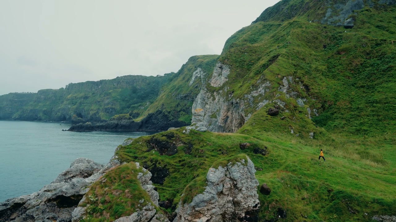 Hiker Walks Along Coastal Cliffs at Kinbane Castle