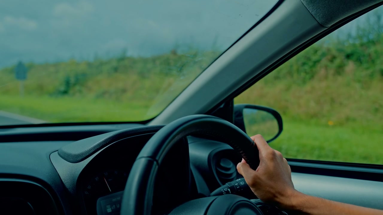 Person Driving Car on Countryside Road