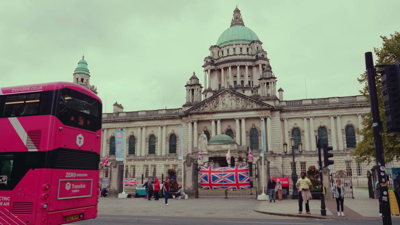 Pink Double-Decker Bus Passing Belfast City Hall
