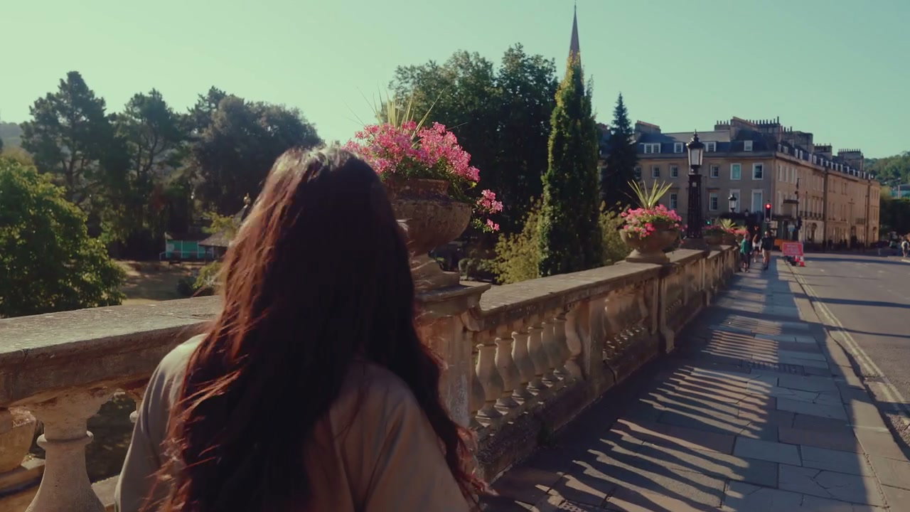 Woman Walking on Historic Bridge in Bath, England