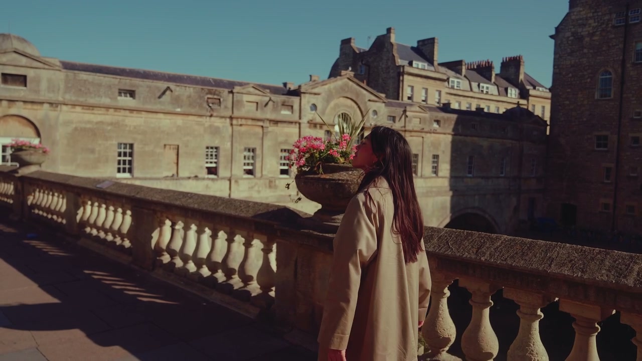 Woman Walking Past Historic Architecture in Bath, England