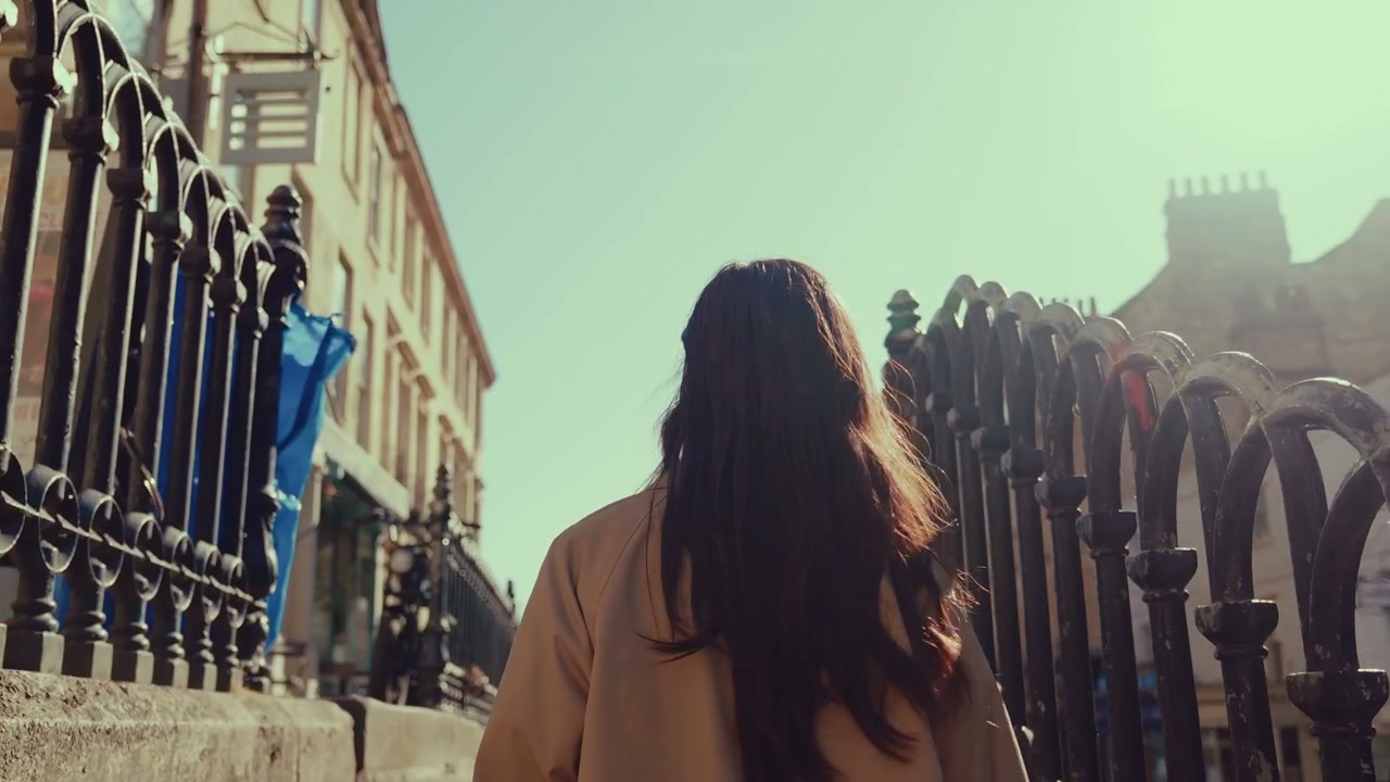 Woman Walking on Sunny Street in Bath, England