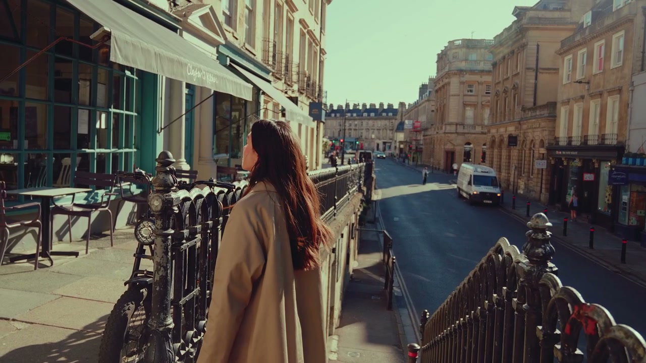 Young Woman Walking Down Street in Bath, England
