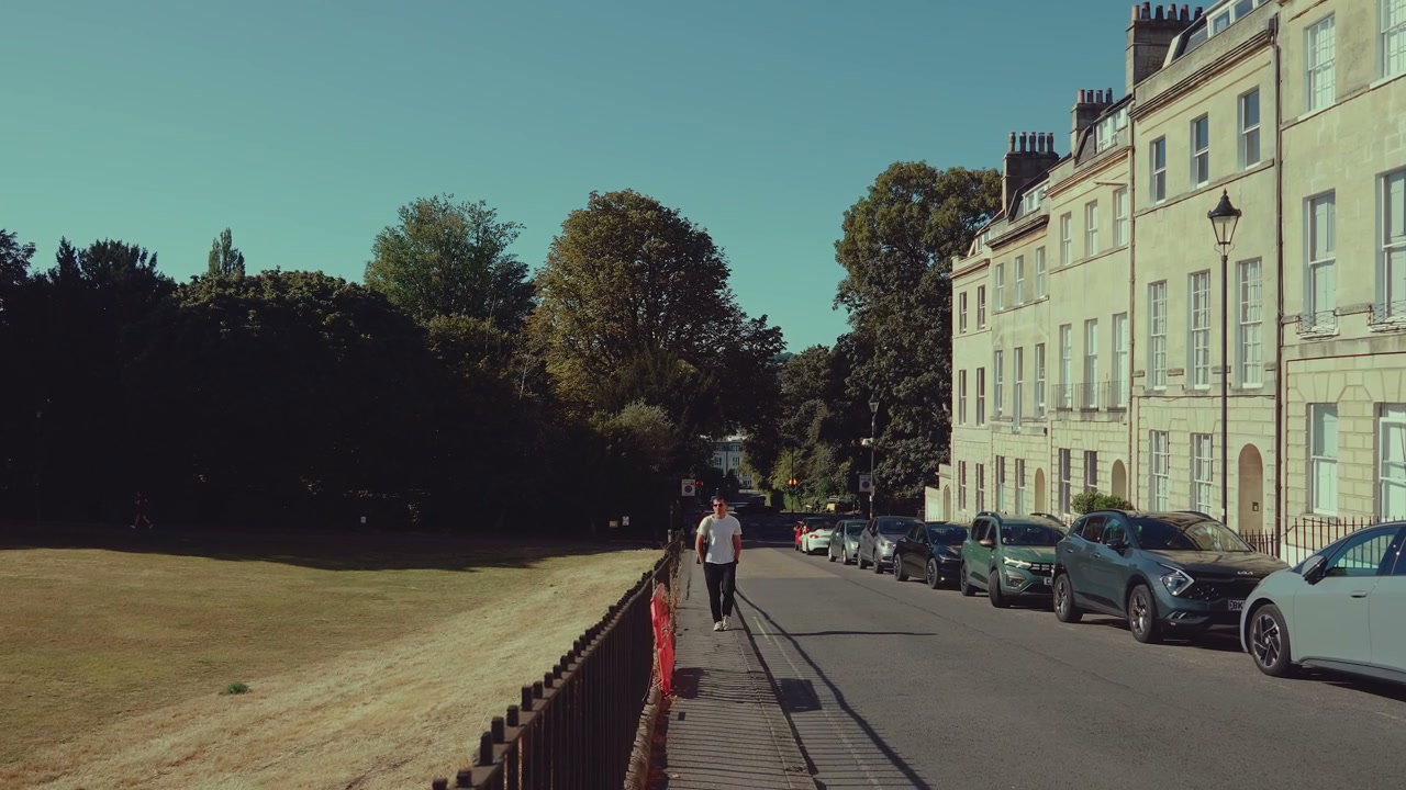 Man Walking By Georgian Architecture in Bath