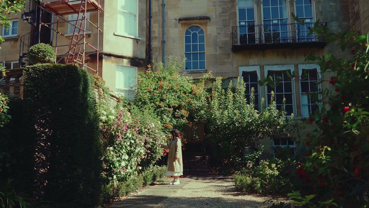 Person Walking Through Elegant Garden in Bath