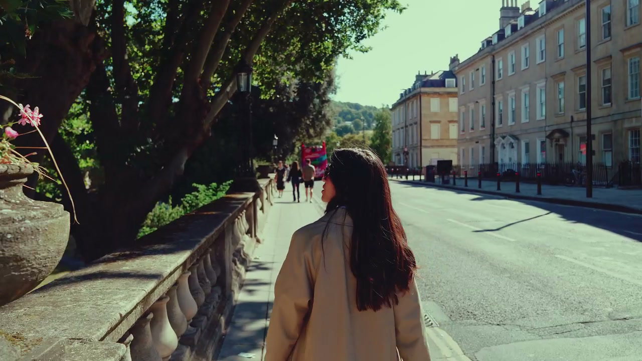 Person Walking on Sunny Street in Bath, England