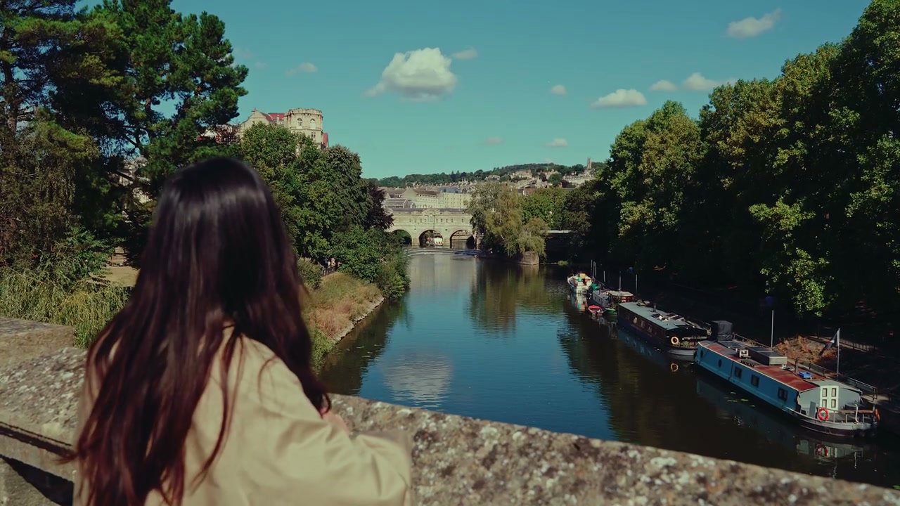 Woman Looking Over Pulteney Bridge, Bath England