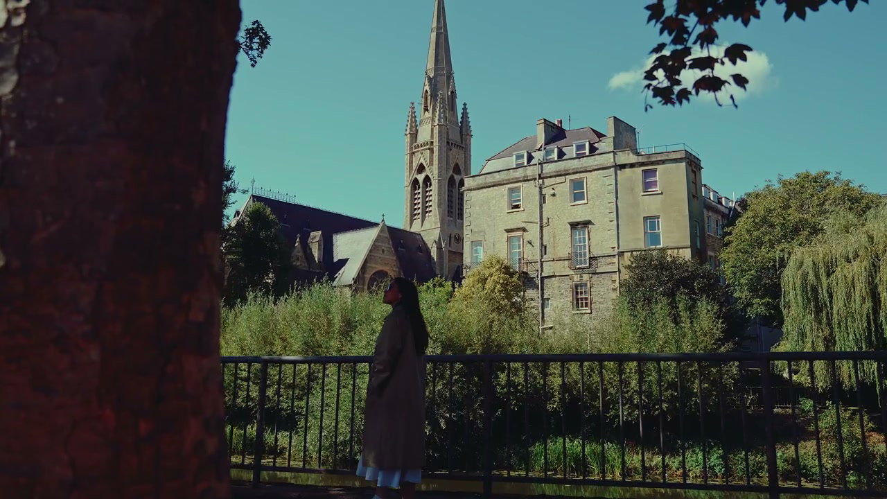 Person Strolling by River in Bath, England