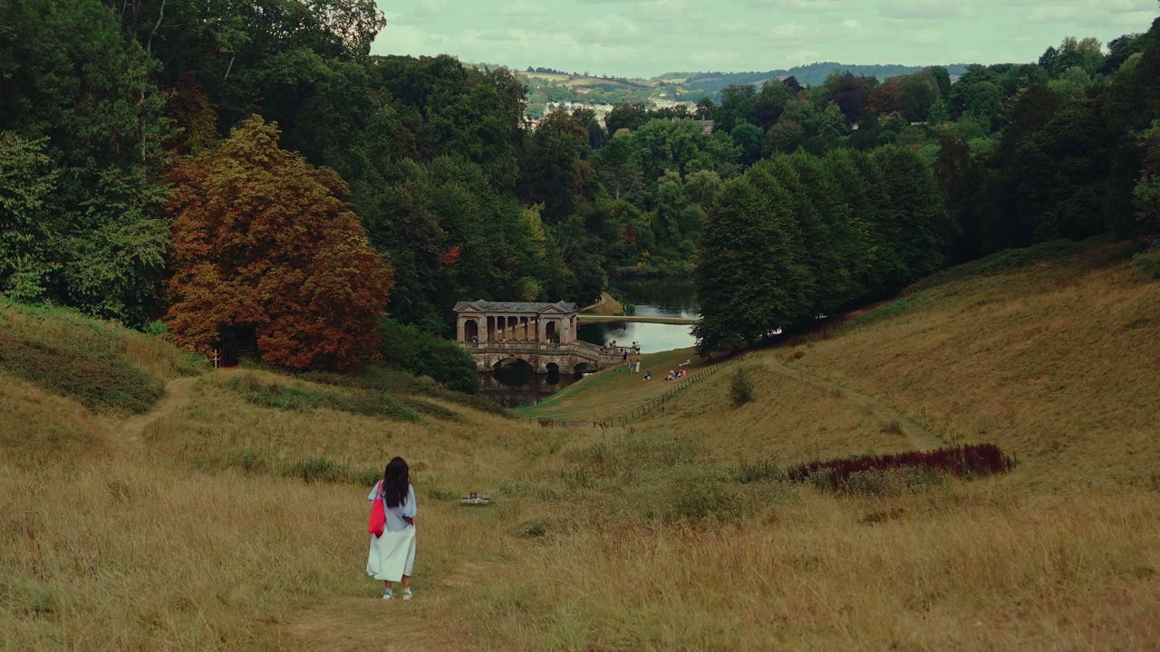 Person Walking Towards Palladian Bridge in Bath