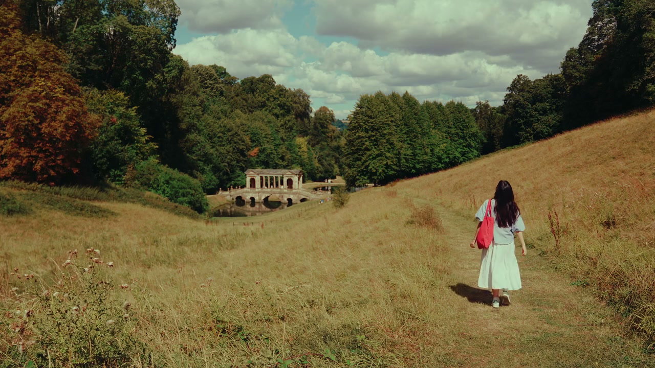 Woman Walking Towards Palladian Bridge in Bath