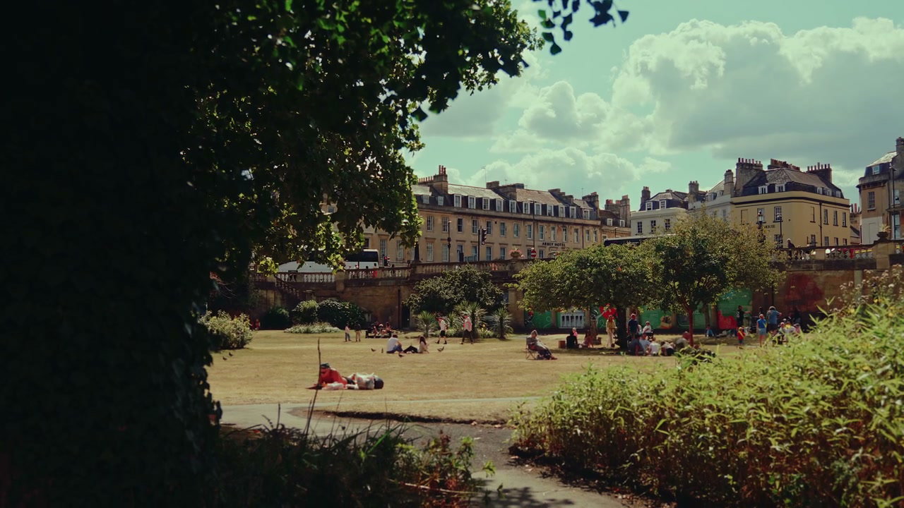 People Relaxing in a Park on a Sunny Day in Bath