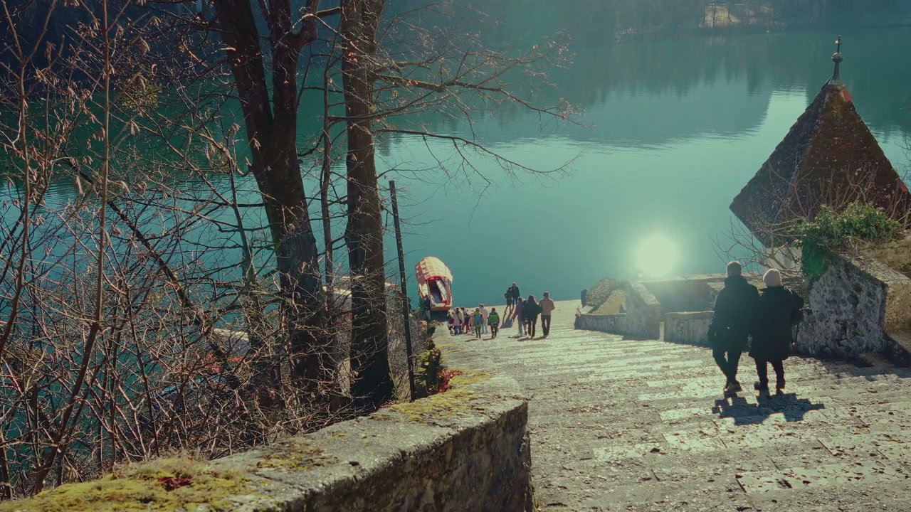People Walking Down Stone Stairs to Lake Bled