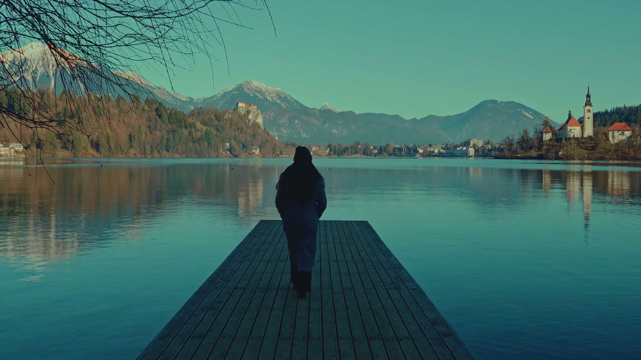 Woman Walking on Pier at Lake Bled