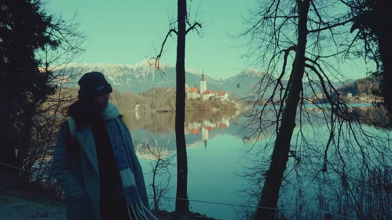Person Walking by Lake Bled Island Church