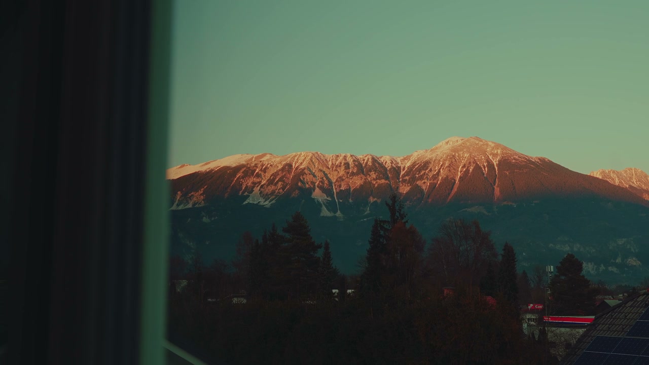 Snowy Mountain Peaks at Golden Hour in Bled