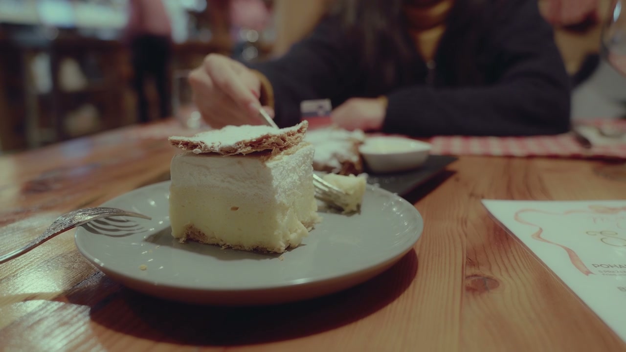 Woman Eating Traditional Bled Cream Cake