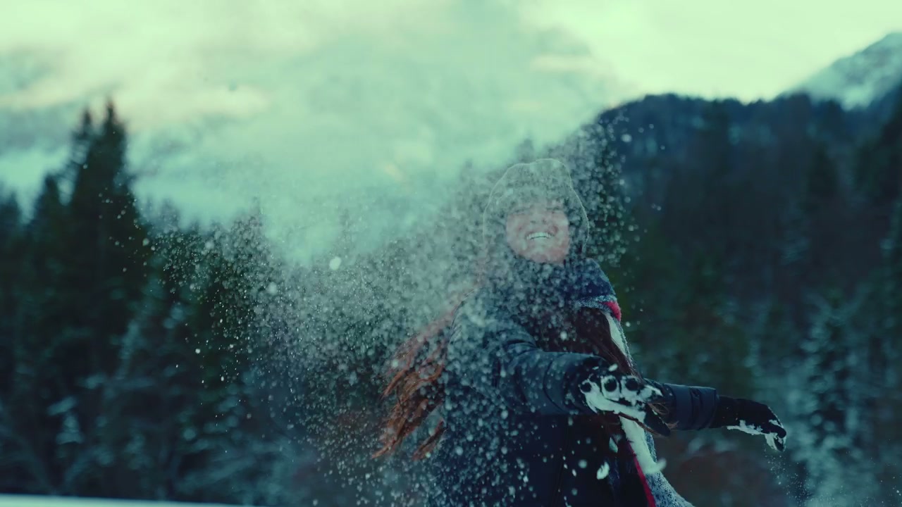 Woman Throws Snow in Winter Mountains