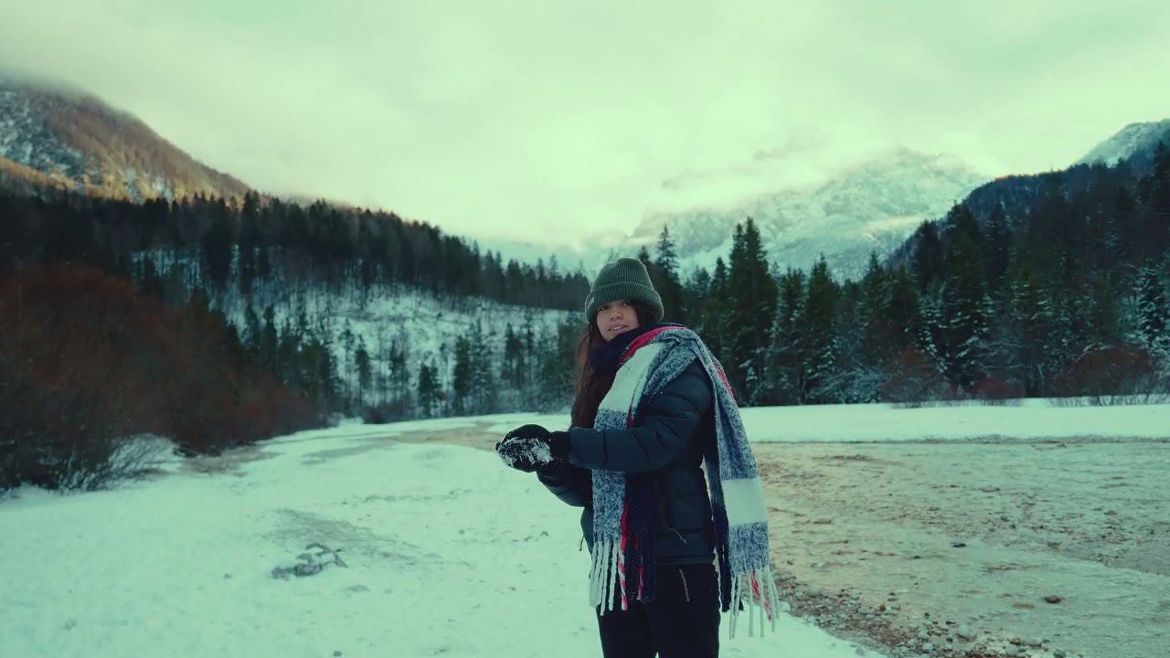 Person Throwing Snow in Winter Mountains