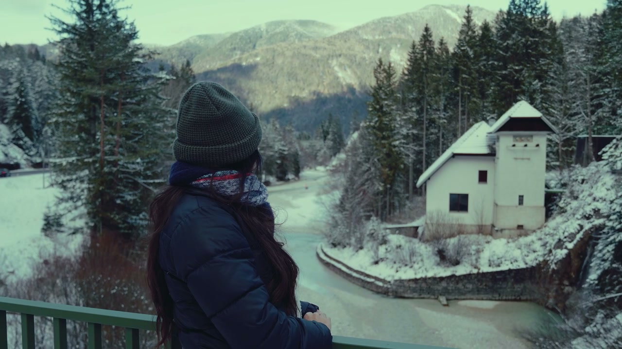 Woman Views Snowy Lake Jasna in Winter