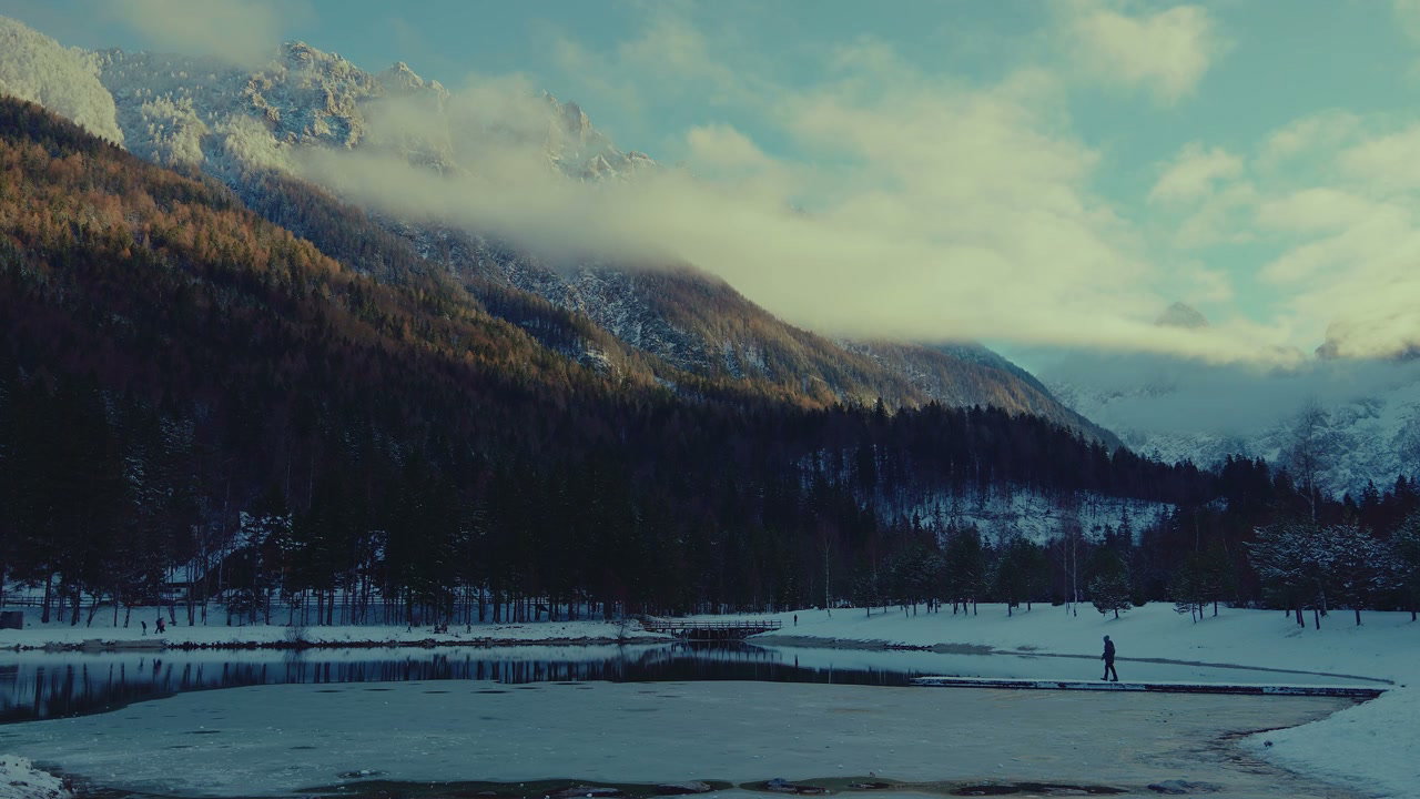 Person Walking By Frozen Lake Jasna in Winter