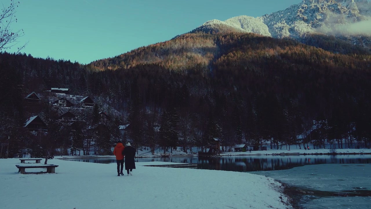 Couple Strolling Along Snowy Lake Jasna