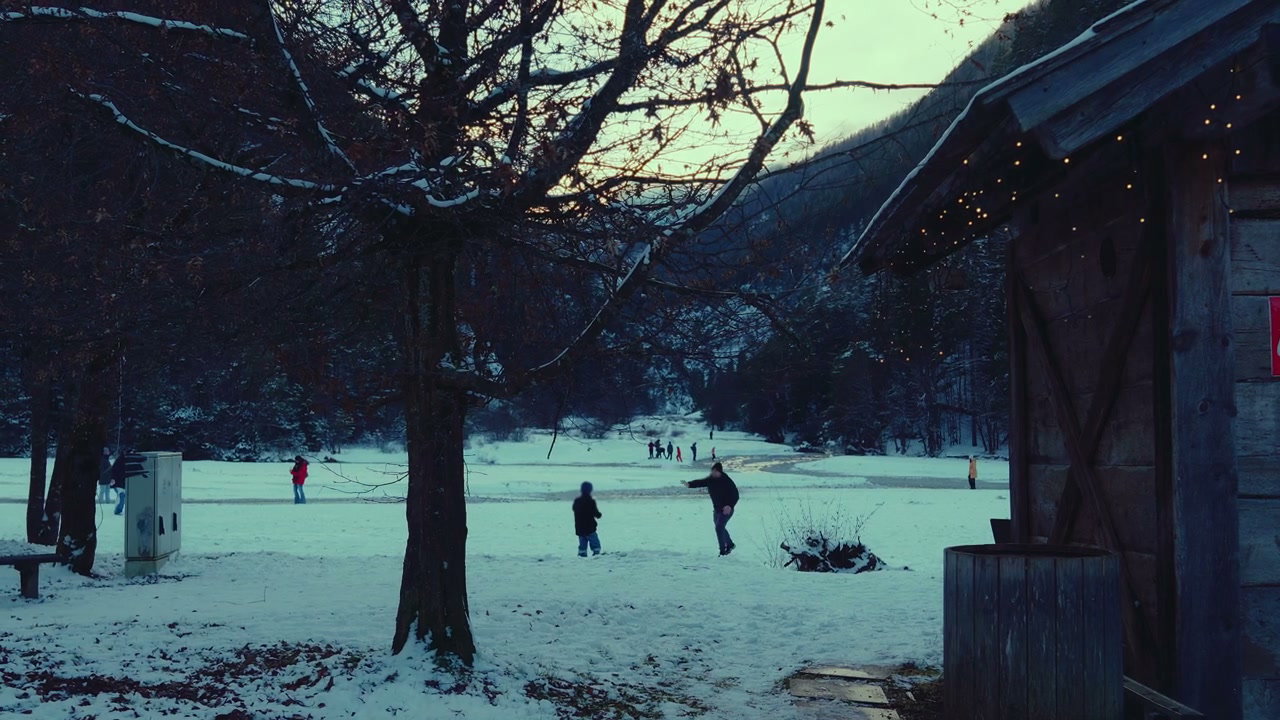 Child and Man Playing in Snow at Lake Jasna