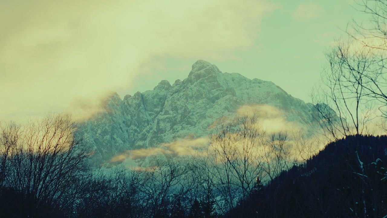 Clouds Over Snow-Capped Alpine Mountain