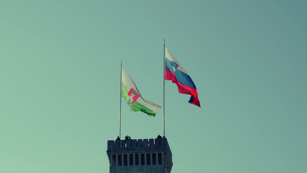 Slovenian and Ljubljana Flags Waving on Tower