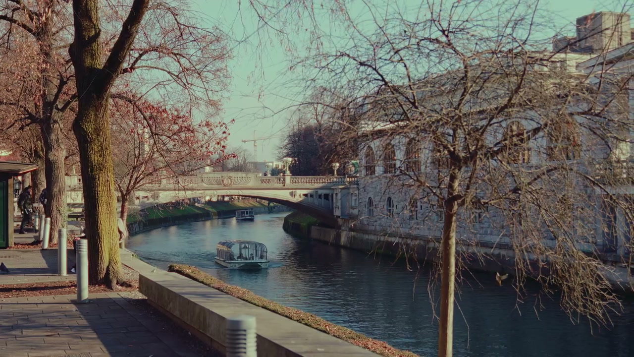 Boats on Ljubljana River with Bridge