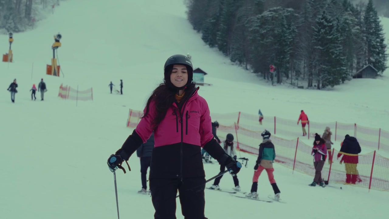 Young Woman Skier on Snowy Mountain Slope