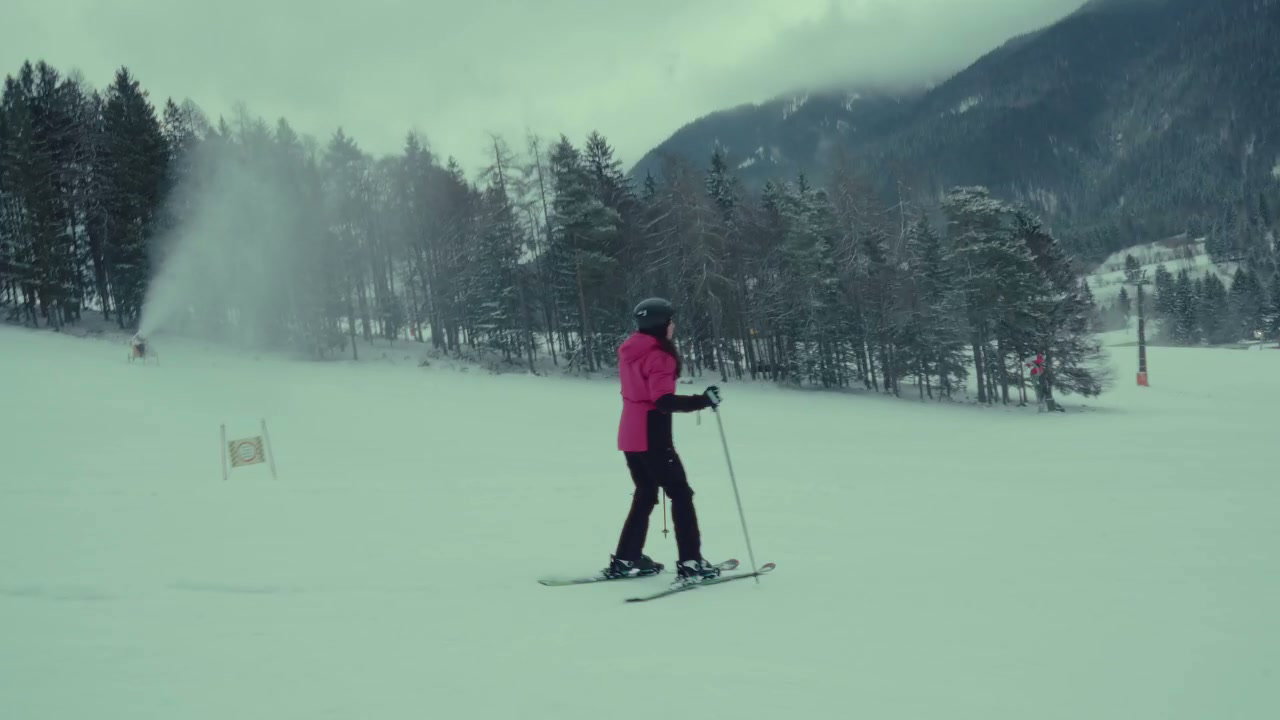 Skier Descending Snowy Mountain Slope