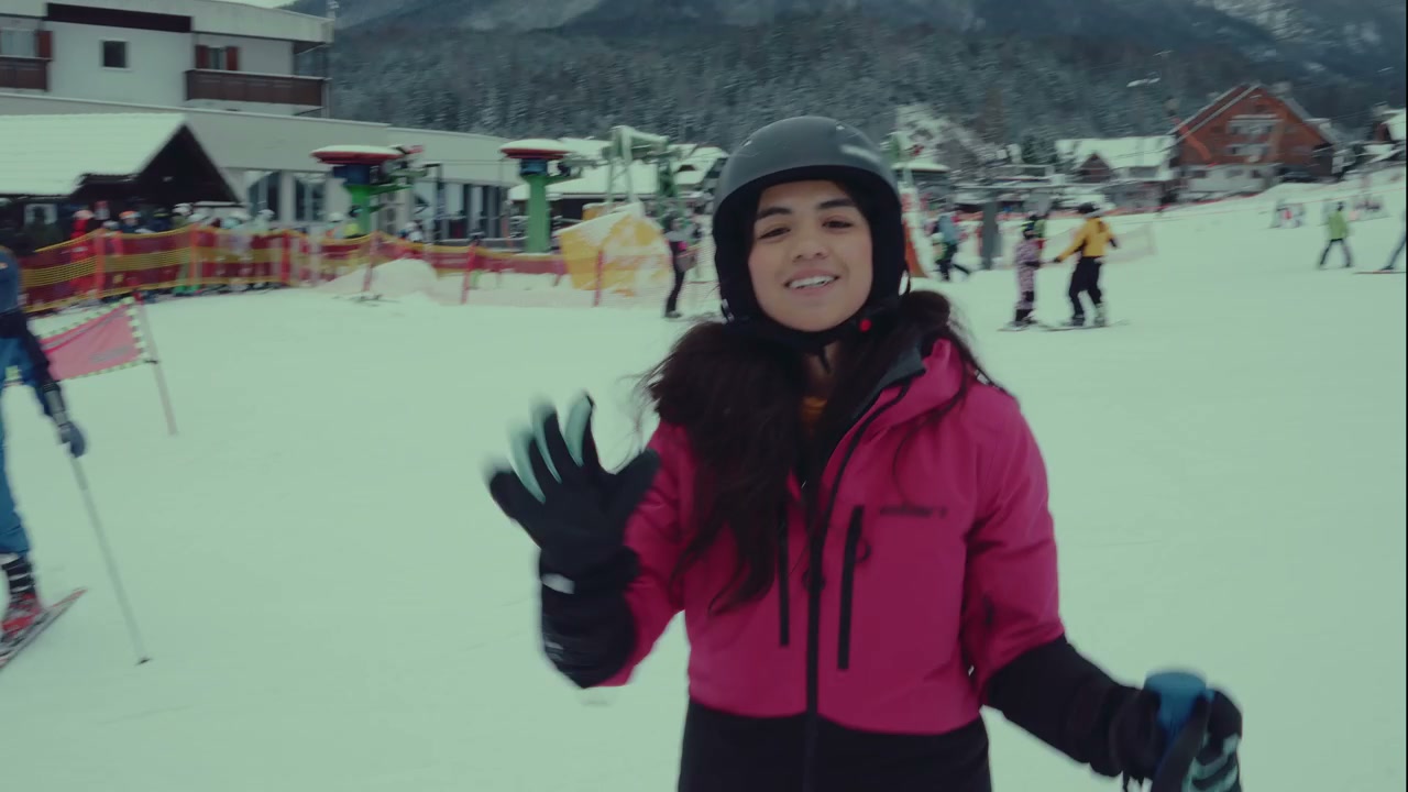 Smiling Woman Gives High Five While Skiing