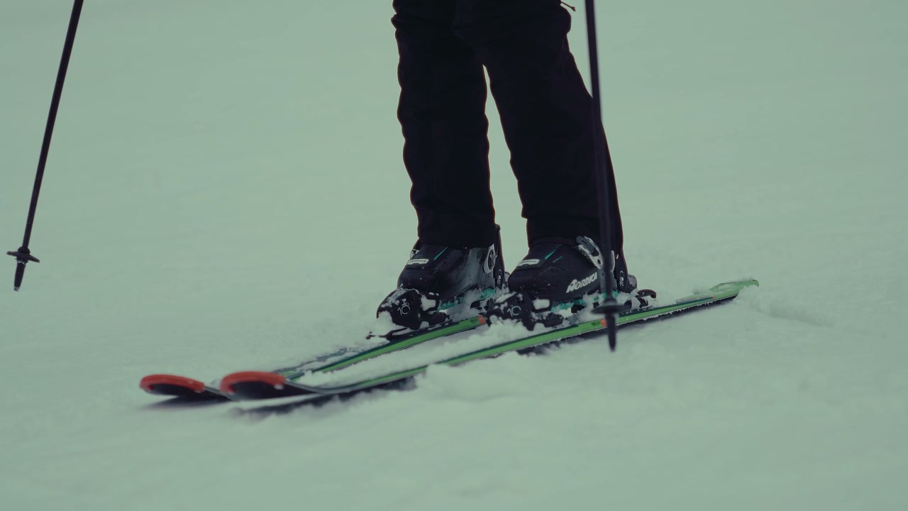 Skier Standing on a Snowy Mountain Slope