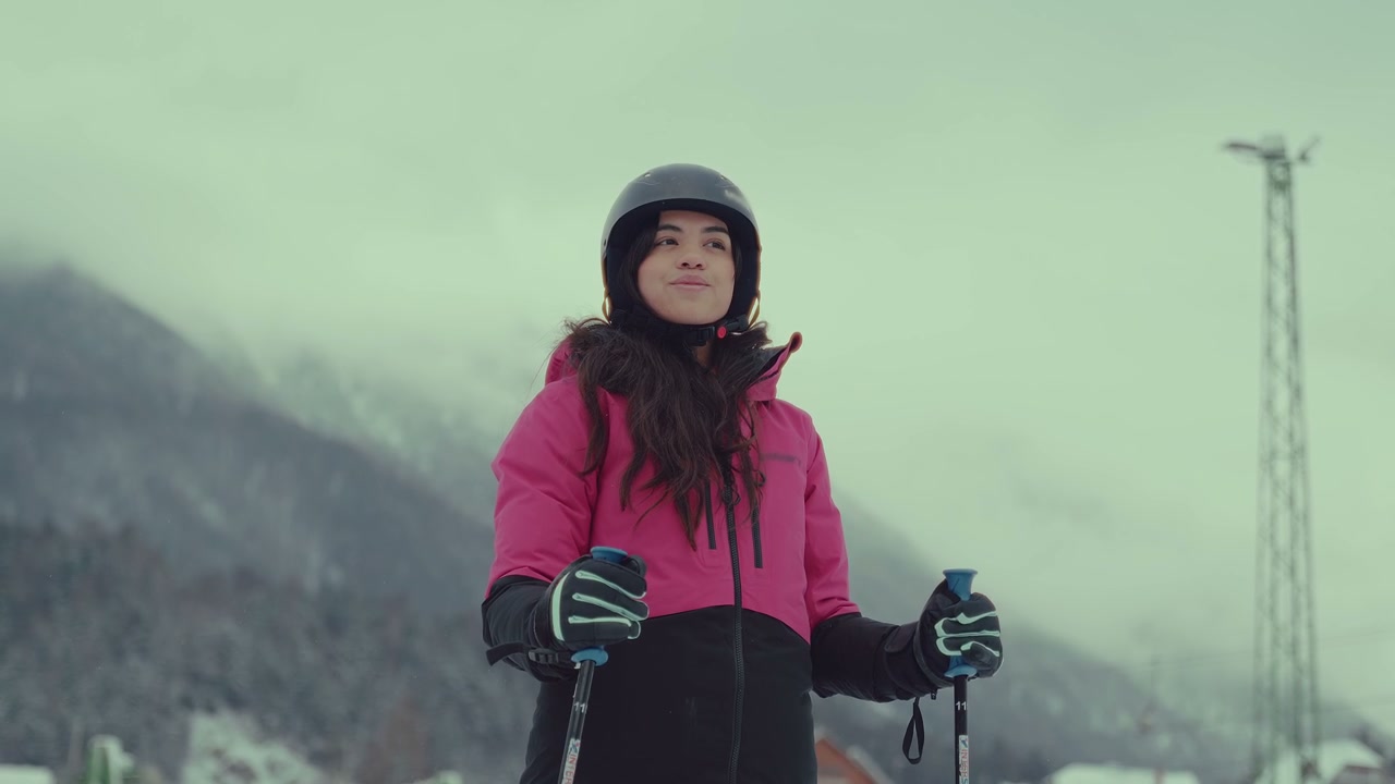 Woman Skier Standing in Snowy Mountains