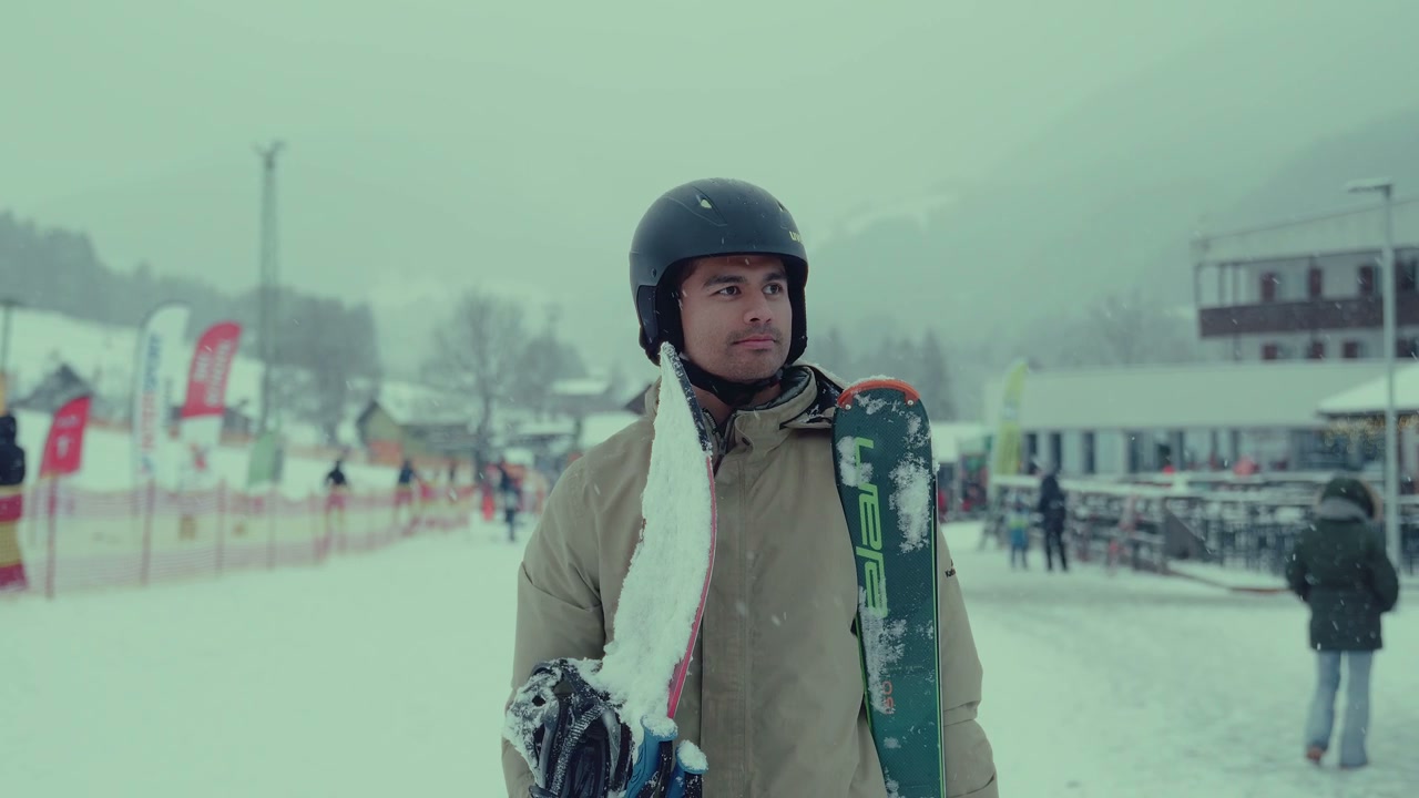 Skier Carrying Equipment at Snowy Resort