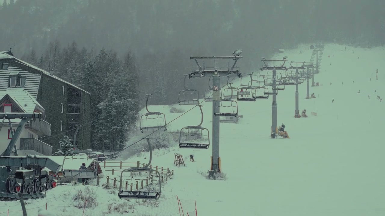 Chairlift Moving Up Snowy Mountain Slope